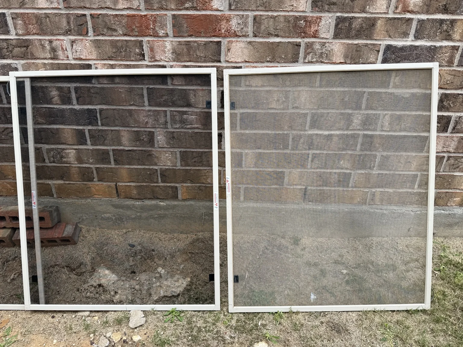 Two window screens side by side, with less visible buildup on the left screen